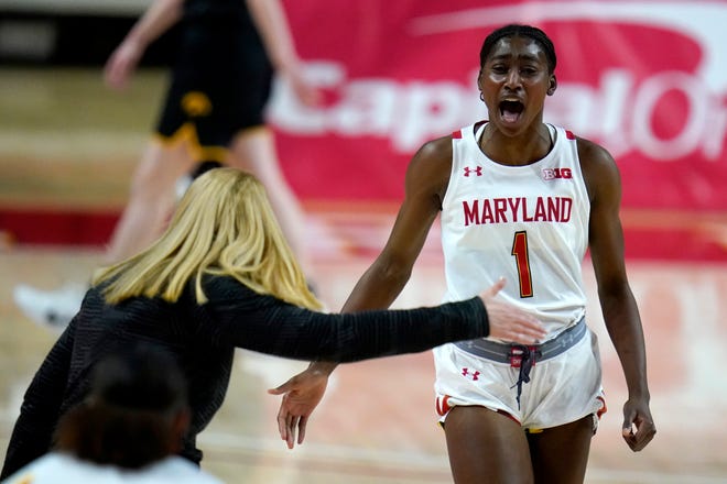 Maryland guard Diamond Miller (1) reacts after scoring a basket as head coach Brenda Frese reaches to congratulate her during the first half of an NCAA college basketball game against the Iowa, Tuesday, Feb. 23, 2021, in College Park, Md.