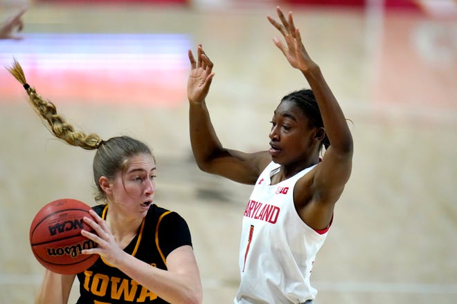 Iowa guard Kate Martin, left, drives to the basket against Maryland guard Diamond Miller during the first half of an NCAA college basketball game, Tuesday, Feb. 23, 2021, in College Park, Md.