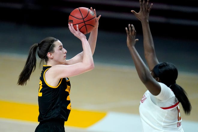Iowa guard Caitlin Clark, left, shoots against Maryland guard Ashley Owusu during the first half of an NCAA college basketball game, Tuesday, Feb. 23, 2021, in College Park, Md.