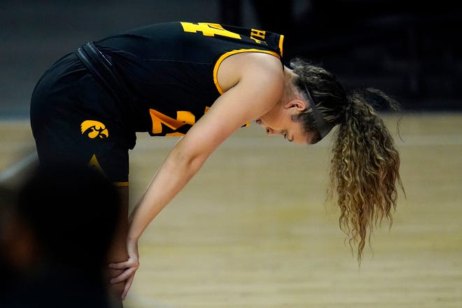 Iowa guard Gabbie Marshall reacts after failing to keep a ball in bounds against the Maryland during the first half of an NCAA college basketball game, Tuesday, Feb. 23, 2021, in College Park, Md.