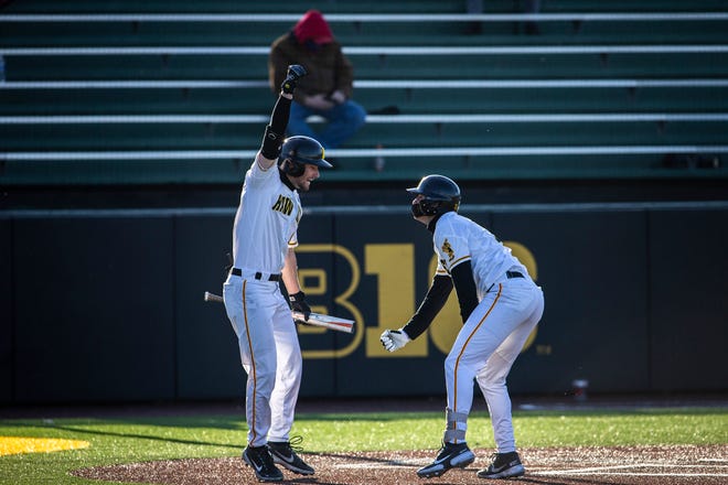 Iowa's Ben Norman, left, celebrates with teammate Brendan Sher after he scored a home run during a NCAA Big Ten Conference baseball game against Nebraska, Friday, March 19, 2021, at Duane Banks Field in Iowa City, Iowa.