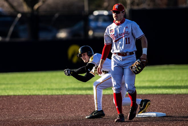 Iowa's Brayden Frazier reacts after hitting a double as Nebraska's Jack Steil, right, looks on during a NCAA Big Ten Conference baseball game, Friday, March 19, 2021, at Duane Banks Field in Iowa City, Iowa.