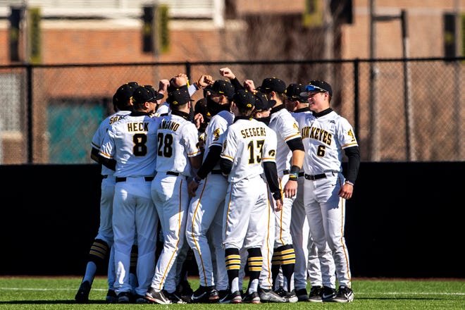 Iowa Hawkeyes players huddle up during a NCAA Big Ten Conference baseball game against Nebraska, Friday, March 19, 2021, at Duane Banks Field in Iowa City, Iowa.