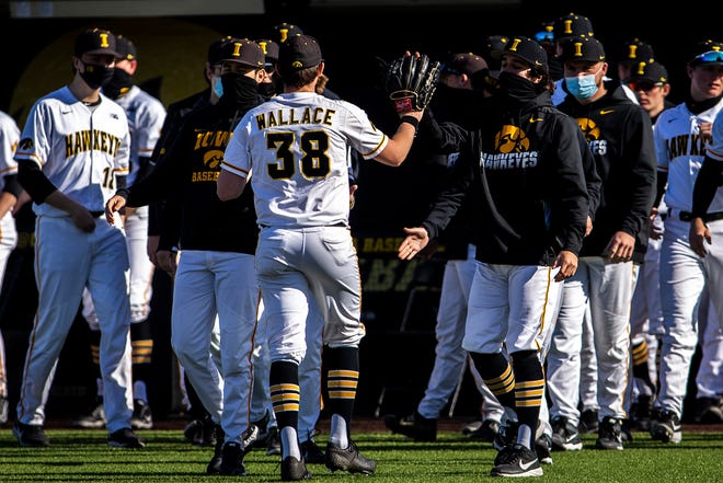 Iowa pitcher Trenton Wallace (38) is greeted by teammates after closing out an inning during a NCAA Big Ten Conference baseball game against Nebraska, Friday, March 19, 2021, at Duane Banks Field in Iowa City, Iowa.
