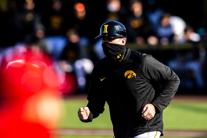 Iowa head coach Rick Heller runs out to third base during a NCAA Big Ten Conference baseball game against Nebraska, Friday, March 19, 2021, at Duane Banks Field in Iowa City, Iowa.