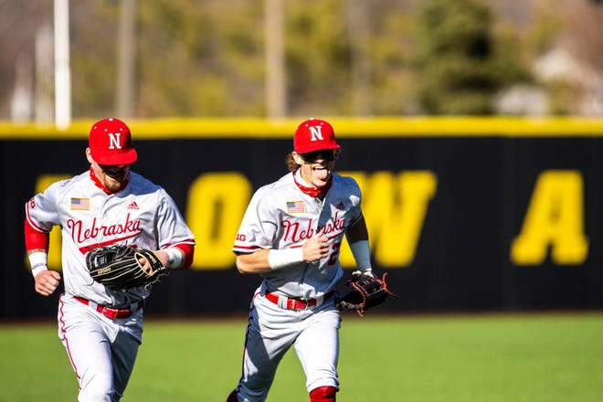Nebraska outfielders Logan Foster, left, and Jaxon Hallmark run into the dugout after an inning during a NCAA Big Ten Conference baseball game against Iowa, Friday, March 19, 2021, at Duane Banks Field in Iowa City, Iowa.