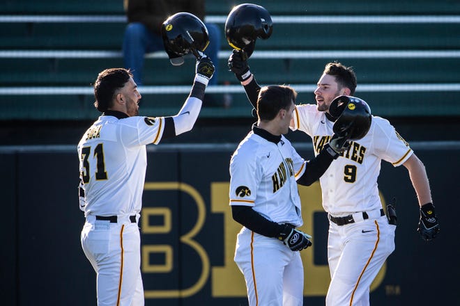 Iowa's Ben Norman (9) celebrates with Iowa's Matthew Sosa (31) after hitting a home run during a NCAA Big Ten Conference baseball game against Nebraska, Friday, March 19, 2021, at Duane Banks Field in Iowa City, Iowa.