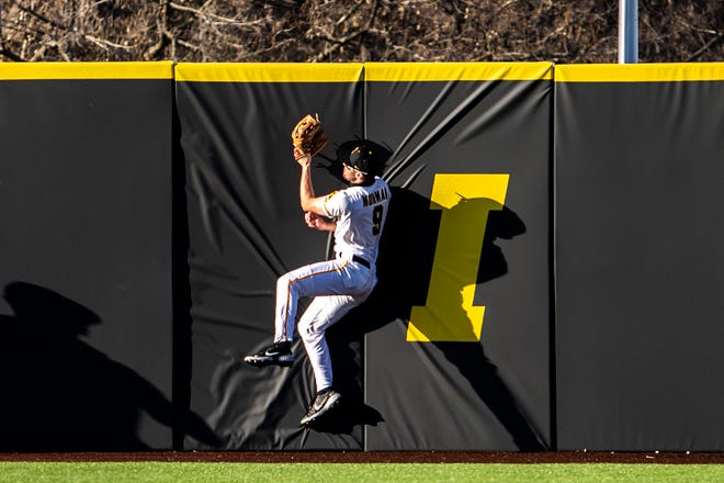 Iowa's Ben Norman (9) catches an out against the outfield wall during a NCAA Big Ten Conference baseball game against Nebraska, Friday, March 19, 2021, at Duane Banks Field in Iowa City, Iowa.