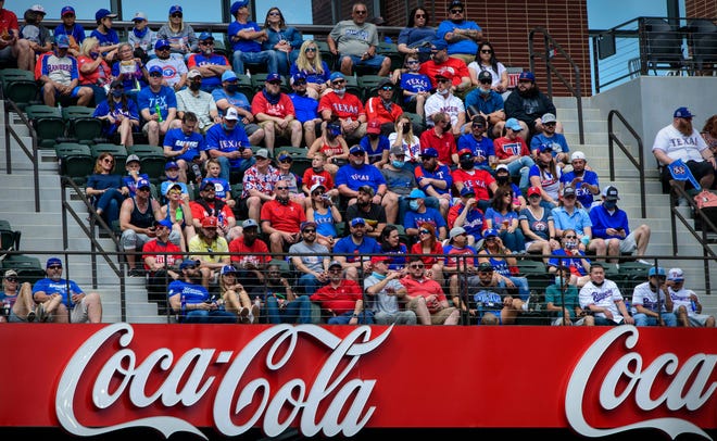 Fans watch the Rangers' home opener against the Blue Jays at Globe Life Park in Arlington, Texas.