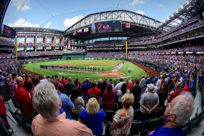 A view of the fans and the stands during the playing of the Canadian and U.S. national anthems before the game between the Texas Rangers and the Toronto Blue Jays at Globe Life Field. The Rangers opened their stadium for 100% attendance, the first such sporting event since the start of the coronavirus pandemic in March 2020.