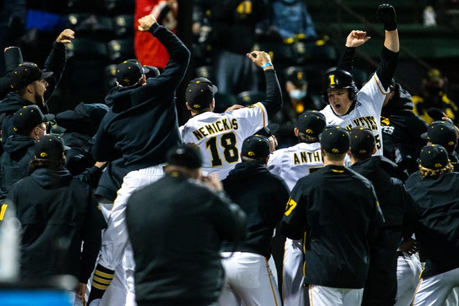 Iowa's Peyton Williams (45) celebrates with teammates after hitting a grand slam home run during a NCAA Big Ten Conference baseball game against Minnesota, Friday, April 9, 2021, at Duane Banks Field in Iowa City, Iowa.