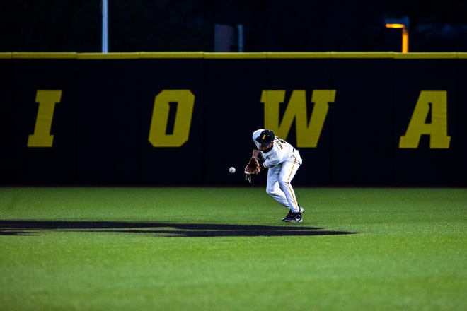 Iowa's Ben Norman (9) fields a ball in center field during a NCAA Big Ten Conference baseball game against Minnesota, Friday, April 9, 2021, at Duane Banks Field in Iowa City, Iowa.