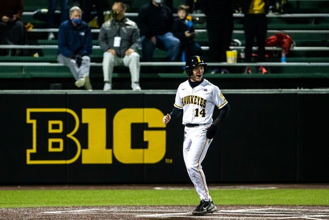 Iowa's Andy Nelson (14) reacts while scoring a run during a NCAA Big Ten Conference baseball game against Minnesota, Friday, April 9, 2021, at Duane Banks Field in Iowa City, Iowa.