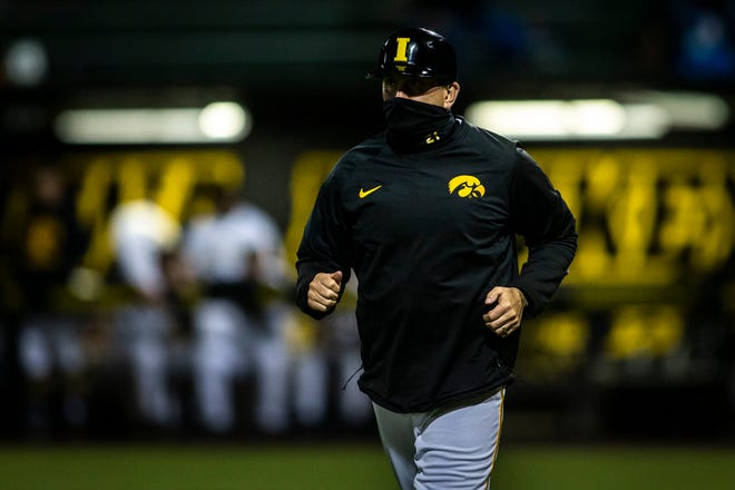 Iowa head coach Rick Heller runs out to third base during a NCAA Big Ten Conference baseball game against Minnesota, Friday, April 9, 2021, at Duane Banks Field in Iowa City, Iowa.