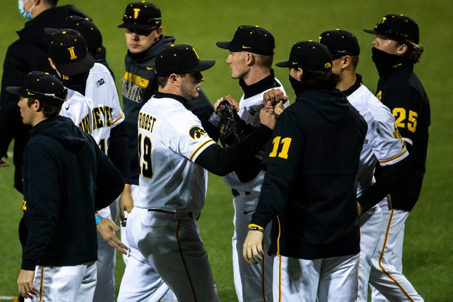 Iowa's Ben Probst (19) is greeted by teammates after closing out an inning during a NCAA Big Ten Conference baseball game against Minnesota, Friday, April 9, 2021, at Duane Banks Field in Iowa City, Iowa.