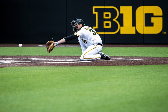 Iowa catcher Brett McCleary (32) helps a pitcher warm up during a NCAA Big Ten Conference baseball game against Minnesota, Friday, April 9, 2021, at Duane Banks Field in Iowa City, Iowa.