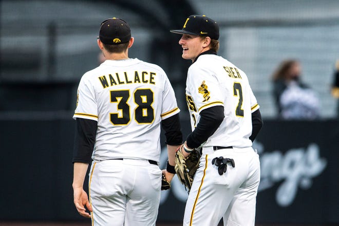 Iowa's Brendan Sher (2) talks with pitcher Trenton Wallace (38) during a NCAA Big Ten Conference baseball game against Minnesota, Friday, April 9, 2021, at Duane Banks Field in Iowa City, Iowa.