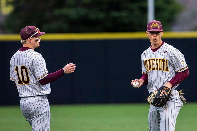 Minnesota's Jack Wassel, right, reacts after getting an out as teammate Drew Stahl (10) looks on during a NCAA Big Ten Conference baseball game against Iowa, Friday, April 9, 2021, at Duane Banks Field in Iowa City, Iowa.