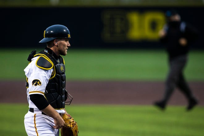 Iowa catcher Austin Martin (34) gets set behind home plate during a NCAA Big Ten Conference baseball game against Minnesota, Friday, April 9, 2021, at Duane Banks Field in Iowa City, Iowa.