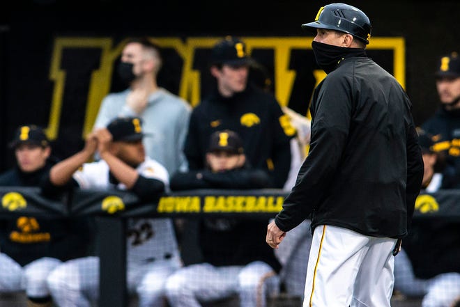 Iowa head coach Rick Heller watches players warm up between innings during a NCAA Big Ten Conference baseball game against Minnesota, Friday, April 9, 2021, at Duane Banks Field in Iowa City, Iowa.