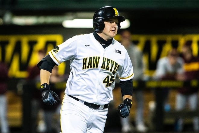 Iowa's Peyton Williams (45) rounds first base after hitting a grand slam home run during a NCAA Big Ten Conference baseball game against Minnesota, Friday, April 9, 2021, at Duane Banks Field in Iowa City, Iowa.