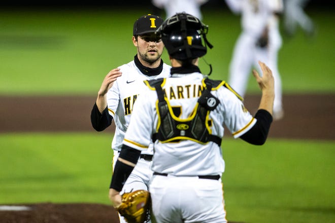 Iowa pitcher Grant Leonard, left, celebrates with catcher Austin Martin after a NCAA Big Ten Conference baseball game against Minnesota, Friday, April 9, 2021, at Duane Banks Field in Iowa City, Iowa.