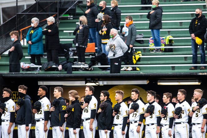 Iowa Hawkeyes players stand as the national anthem is played before a NCAA Big Ten Conference baseball game against Minnesota, Friday, April 9, 2021, at Duane Banks Field in Iowa City, Iowa.