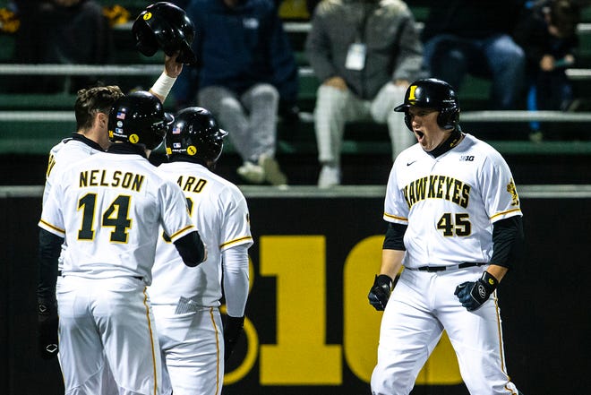 Iowa's Peyton Williams (45) celebrates with teammates after hitting a home run during a NCAA Big Ten Conference baseball game against Minnesota, Friday, April 9, 2021, at Duane Banks Field in Iowa City, Iowa.