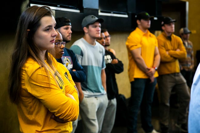 Rachel Watters, a member of the Hawkeye Wrestling Club, listens during a news conference announcing the University of Iowa is starting an NCAA college women's wrestling program, Thursday, Sept. 23, 2021, at Carver-Hawkeye Arena in Iowa City, Iowa.