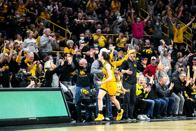 Iowa guard Caitlin Clark (22) reacts after making a 3-point basket during a NCAA Big Ten Conference women's basketball game against Michigan, Sunday, Feb. 27, 2022, at Carver-Hawkeye Arena in Iowa City, Iowa.