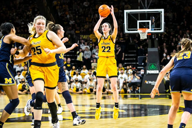 Iowa guard Caitlin Clark (22) makes a 3-point basket during a NCAA Big Ten Conference women's basketball game against Michigan, Sunday, Feb. 27, 2022, at Carver-Hawkeye Arena in Iowa City, Iowa.