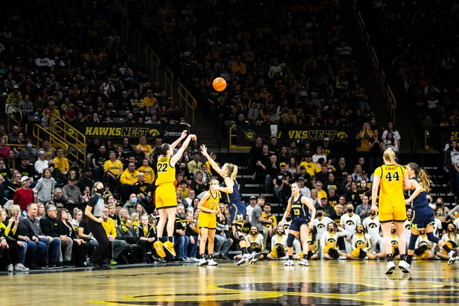 Iowa guard Caitlin Clark (22) makes a 3-point basket during a NCAA Big Ten Conference women's basketball game against Michigan, Sunday, Feb. 27, 2022, at Carver-Hawkeye Arena in Iowa City, Iowa.
