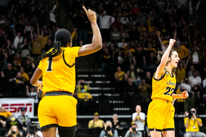 Iowa guard Caitlin Clark, right, celebrates with Iowa guard Tomi Taiwo (1) during a NCAA Big Ten Conference women's basketball game against Michigan, Sunday, Feb. 27, 2022, at Carver-Hawkeye Arena in Iowa City, Iowa.