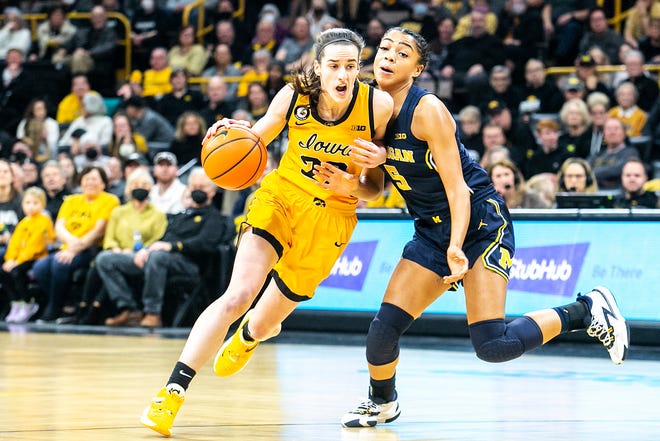 Iowa guard Caitlin Clark, left, drives to the basket against Michigan guard Laila Phelia during a NCAA Big Ten Conference women's basketball game, Sunday, Feb. 27, 2022, at Carver-Hawkeye Arena in Iowa City, Iowa.