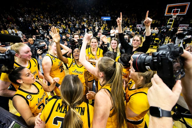 Iowa Hawkeyes players celebrate after a NCAA Big Ten Conference women's basketball game against Michigan, Sunday, Feb. 27, 2022, at Carver-Hawkeye Arena in Iowa City, Iowa.