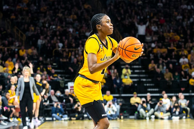 Iowa guard Tomi Taiwo (1) makes a 3-point basket during a NCAA Big Ten Conference women's basketball game against Michigan, Sunday, Feb. 27, 2022, at Carver-Hawkeye Arena in Iowa City, Iowa.