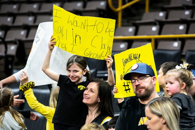 A fan holds a sign reading "I want to be Caitlin Clark when I grow up" after a NCAA Big Ten Conference women's basketball game against Michigan, Sunday, Feb. 27, 2022, at Carver-Hawkeye Arena in Iowa City, Iowa.