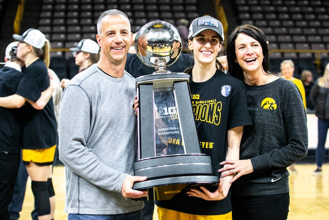 Iowa guard Caitlin Clark poses for a photo while holding their Big Ten regular season championship trophy after a NCAA Big Ten Conference women's basketball game against Michigan, Sunday, Feb. 27, 2022, at Carver-Hawkeye Arena in Iowa City, Iowa.