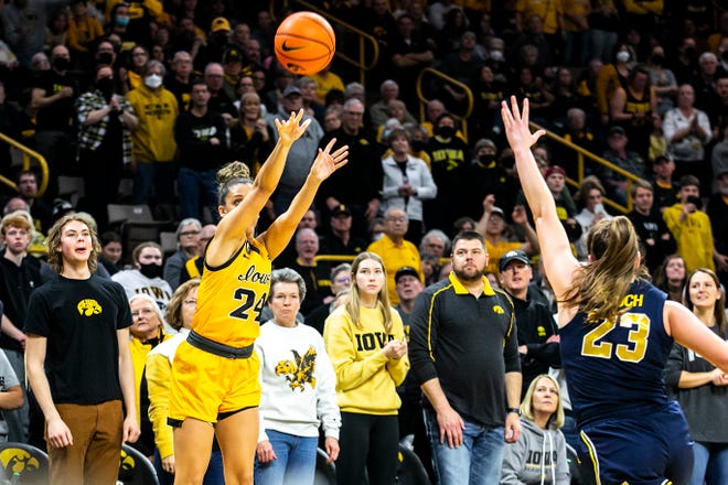 Iowa guard Gabbie Marshall (24) makes a 3-point basket as Michigan guard Danielle Rauch defends during a NCAA Big Ten Conference women's basketball game against Michigan, Sunday, Feb. 27, 2022, at Carver-Hawkeye Arena in Iowa City, Iowa.