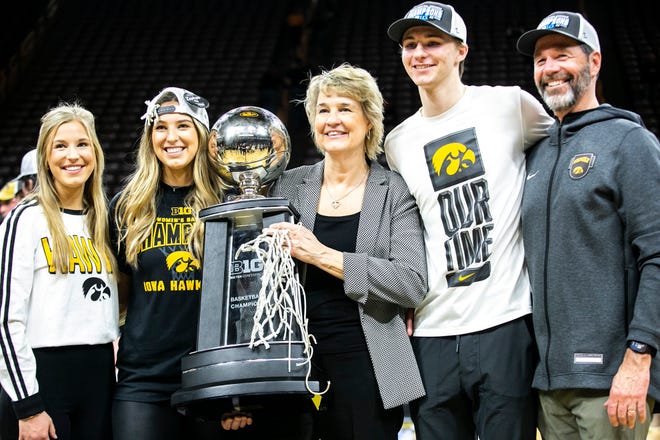 Iowa head coach Lisa Bluder, third from right, poses for a photo with her family after a NCAA Big Ten Conference women's basketball game against Michigan, Sunday, Feb. 27, 2022, at Carver-Hawkeye Arena in Iowa City, Iowa.