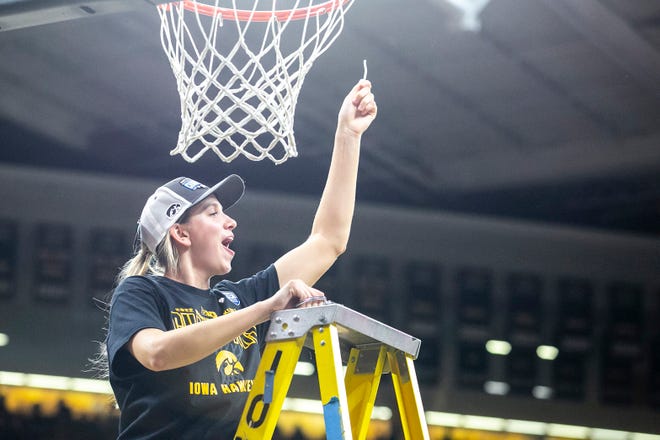 Iowa forward Logan Cook (23) celebrates with a piece of the net after a NCAA Big Ten Conference women's basketball game against Michigan, Sunday, Feb. 27, 2022, at Carver-Hawkeye Arena in Iowa City, Iowa.