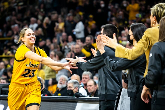 Iowa forward Logan Cook (23) celebrates with teammates during a NCAA Big Ten Conference women's basketball game against Michigan, Sunday, Feb. 27, 2022, at Carver-Hawkeye Arena in Iowa City, Iowa.