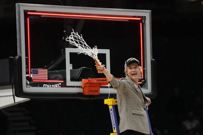 Iowa head coach Lisa Bluder reacts after cutting down the net after the game against the Louisville Cardinals, March 26, 2023, at Climate Pledge Arena in Seattle.