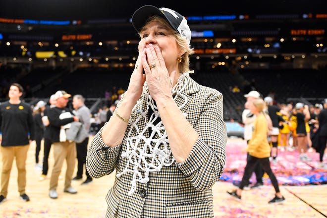 Iowa head coach Lisa Bluder celebrates after defeating the Louisville Cardinals 97-83 in the Elite Eight round of the NCAA Women's Basketball Tournament, March 26, 2023, at Climate Pledge Arena in Seattle.