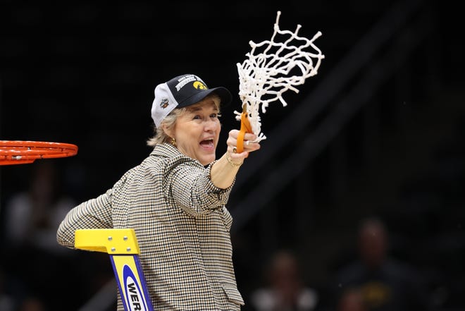 Iowa head coach Lisa Bluder of the Iowa Hawkeyes celebrates after defeating the Louisville Cardinals 97-83 in the Elite Eight round of the NCAA Women's Basketball Tournament, March 26, 2023, at Climate Pledge Arena in Seattle.